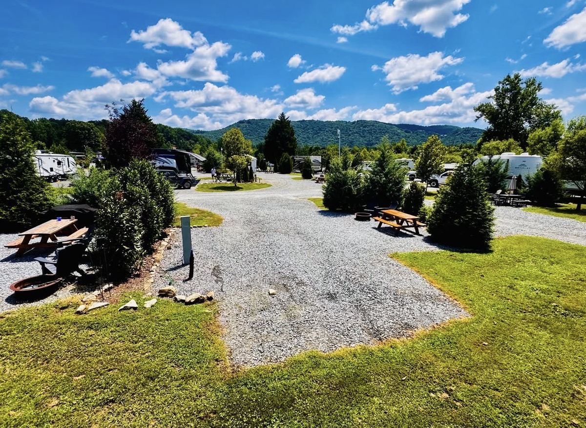 Landscaped gravel RV sites with picnic tables and mountain views